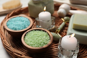 Composition with spa supplies and burning candles on table, closeup