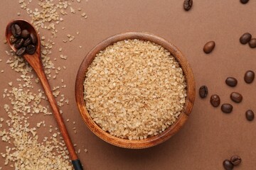 Sea salt and coffee beans on brown background, flat lay