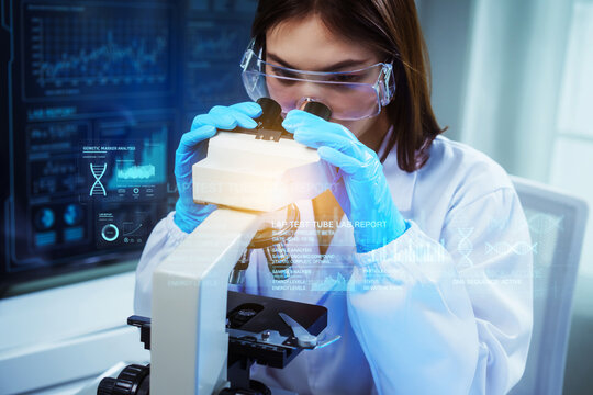 Asian people, focused female scientist wearing safety goggles and blue gloves peers through a microscope, surrounded by holographic data overlays showing DNA analysis and a laboratory report.