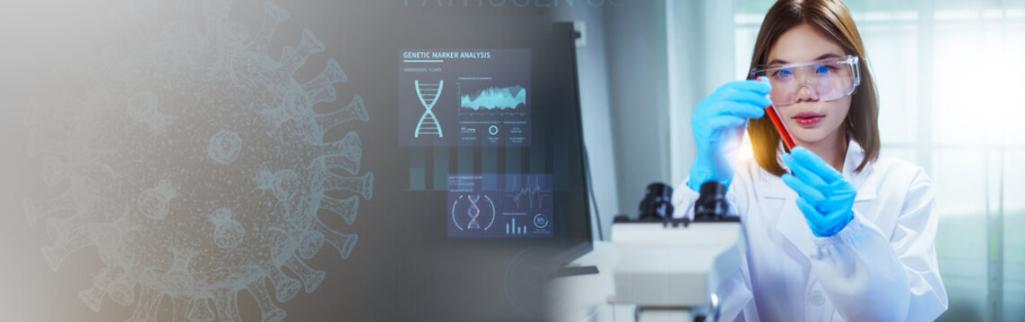 Asian female scientist in blue gloves holds up a test tube containing a blood sample, working near a screen displaying DNA analysis and a faded virus illustration in the background. - Powered by Adobe