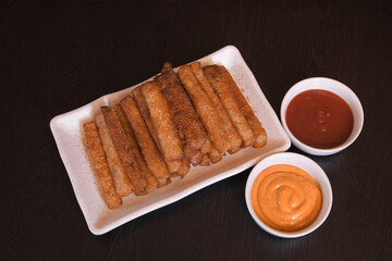 Crispy Potato Fries Served on White Rectangular Plate with Mayonnaise and Ketchup on Dark Background — Delicious Fast Food Concept