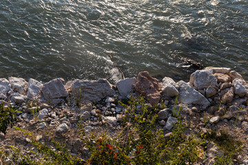 An abstract natural texture of shimmering river water and rugged stones. Perfect as a background for concepts of environment, power, and purity.
