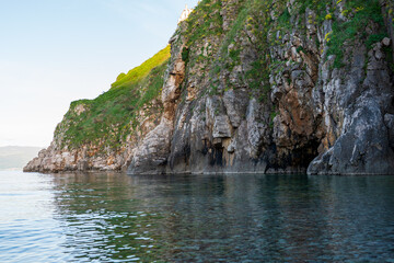 KRK Island, Vrbnik, Croatia - April 19, 2025: Panorama of mountains and water. Beautiful mountain horizon with cliffs and sea.