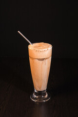 Front View of Cold Coffee Served in Glass with Steel Straw — Refreshing Beverage and Modern Café Concept