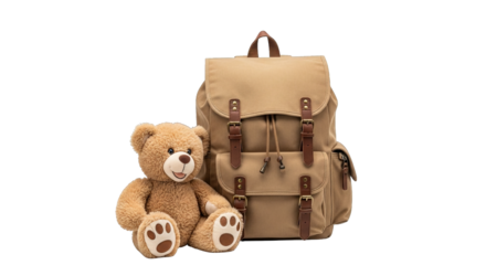 A charming teddy bear sits happily next to a stylish tan backpack with brown leather accents.