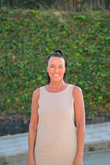 Portrait of a beautiful middle aged Scandinavian woman smiling at the camera outdoors