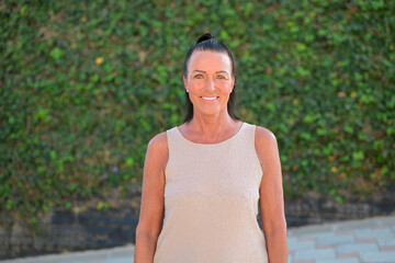 Portrait of a beautiful middle aged Scandinavian woman smiling at the camera outdoors