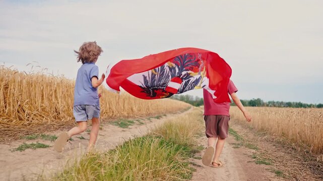 Children running with Austrian flag through golden wheat field under summer sky