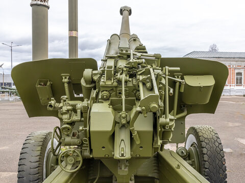 The barrel of a large-caliber cannon is aimed at the gloomy sky. Soviet and Russian artillery. A weapon for long-range strikes. Armed conflicts and wars.