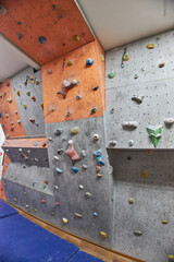 Several climbing surfaces showcase a variety of holds in bright colors, designed for indoor climbing training. walls provide different challenges for climbers of all skill levels