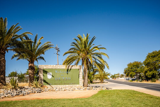The Outjo Welcome Sign in Namibia greets travelers with palm-lined charm