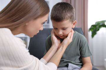 Mother supporting her upset son at home, closeup