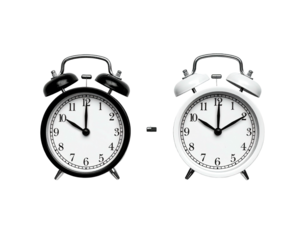 Two black and white alarm clocks, showing different times