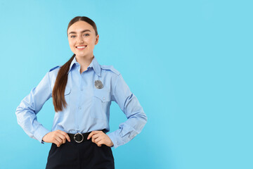 Young policewoman in uniform on light blue background, space for text