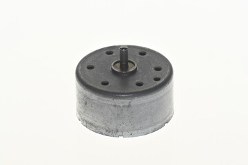 Motor component sits on a plain background showcasing its round design and mounting features for various applications