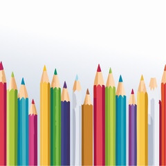 Assortment of colorful pencils in a row against a white background