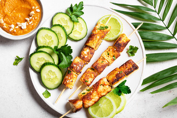 Grilled tofu satay skewers and peanut spicy sauce