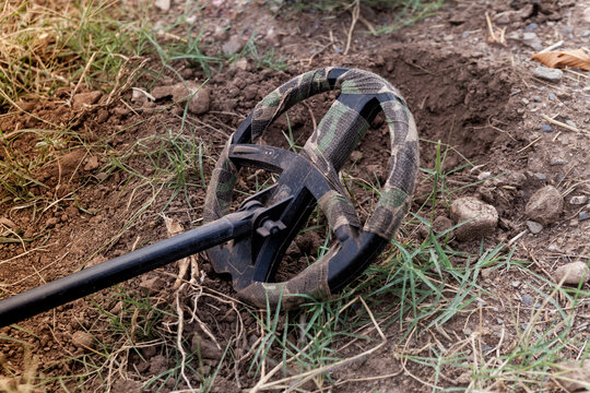 A metal detector for archaeological prospecting, photographed close-up, outdoors.