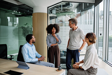 Group of young businesspeople having a meeting or presentation and seminar standing in the office....