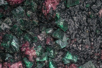 Macro photo crystals. Dioptase mineral: (cobaltocalcite pink; heterogenite black spherulites) copper silicate, DR Congo. Microphotography- 3.7X zoom magnification