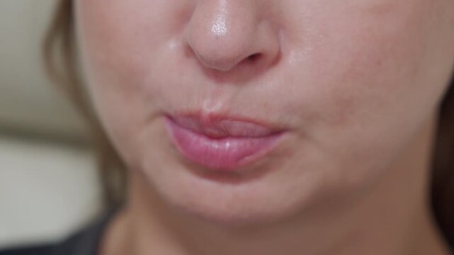 a woman imitating the sound of a cow focusing on her facial expression and mouth shape as she vocalizes.
