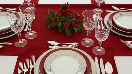 Elegant christmas dinner table setting with red accents