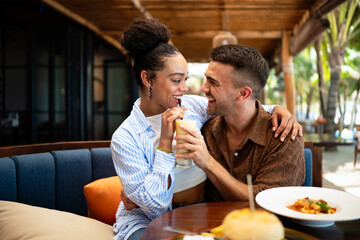 Romantic dining moments, a smiling man enjoys a special meal while holding hands with his partner
