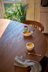 Cottage cheese souffle. Side view. A flowering branch in a vase. Souffle in a ramekin .