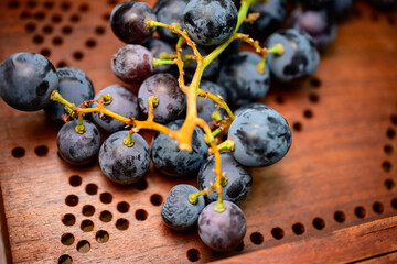 Fresh Purple Grapes on Wooden Surface – Macro Close-Up