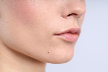 Woman with normal skin on light background, closeup