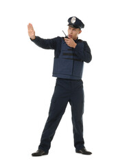 Young policeman in uniform with walkie talkie showing stop gesture on white background
