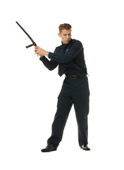 Young policeman in uniform with baton on white background