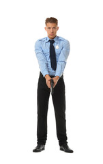 Young policeman in uniform with gun on white background