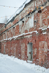 Snow-covered brick wall creates a rustic winter urban scene