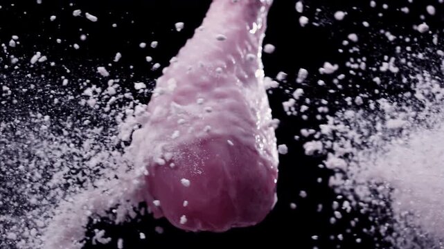 The collision of spices with a chicken drumstick in the air at super slow-motion 1000fps