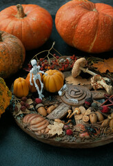 Wiccan altar for Samhain. wheel of the year with amulets, pumpkins close up on dark abstract background. witch stuff. esoteric ritual, magic, Witchcraft concept. symbol of Samhain, Halloween holidays