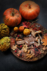 Wiccan altar for Samhain. Pumpkins and wheel of the year with amulets on dark abstract background. witch stuff. esoteric ritual, magic, Witchcraft concept. symbol of Samhain, Halloween holidays