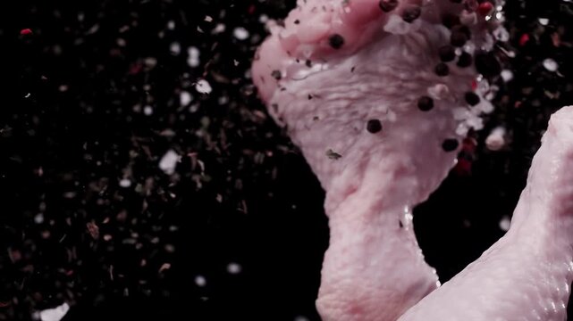 The collision of spices with a chicken drumstick in the air at super slow-motion 1000fps