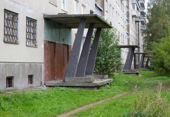 A path in the grass along a multi-storey building made of concrete panels, Iskrovsky Prospekt, Saint Petersburg, Russia, October 06, 2025