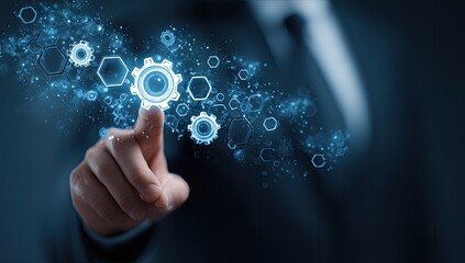 Businessman's finger interacts with glowing digital gears & hexagons, concept of technology