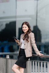 Fototapeta premium Confident Businesswoman Using Smartphone Outdoors