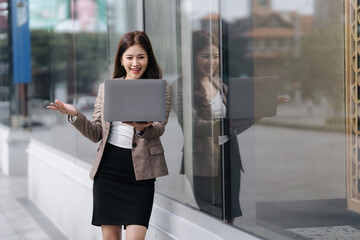 Confident Businesswoman with Laptop Outdoors