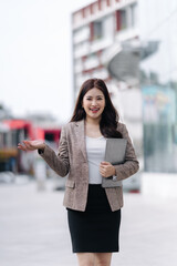 Confident Asian Businesswoman Presenting Outdoors