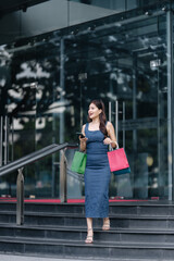 beautiful asia woman female pleased positive casual shopping hand hold paper bags happy woman enjoy purchase cloths shopping buy sales discount at center mall store shopfront corridor department store
