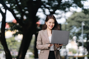 Smiling Woman with Laptop Outdoors