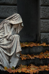 beautiful old tombstone of grieving woman on crypt steps. memorial sad statue on cemetery. Design...