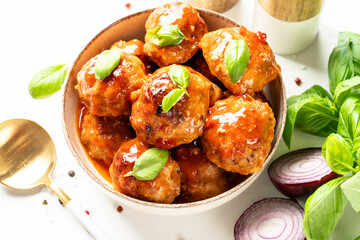 Meatballs in tomato sauce, glazed meatballs in craft plate on white table.