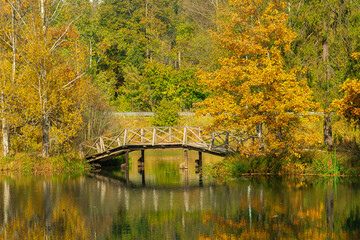 Autumn landscape with a wooden bridge over the Voria River, in Abramtsevo, Moscow Oblast, Russia