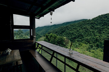 A viewpoint area with a roof and sitting area overlooking lush green jungle