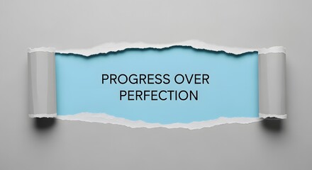 Inspiring progress over perfection message revealed with torn paper, perfect for motivational posters, business presentations, and encouraging personal growth today